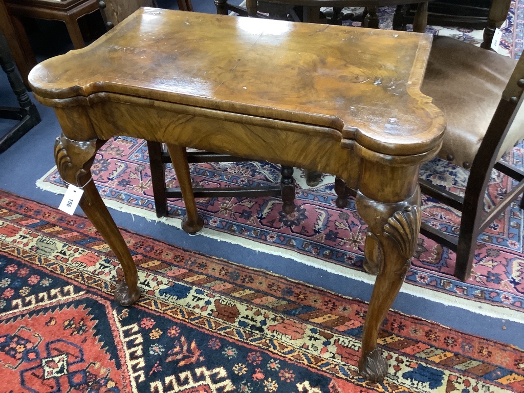 A Queen Anne revival walnut concertina folding card table, stamped Gill and Reigate, London retailed by S & H Jewell, width 81cm, depth 40cm, height 75cm